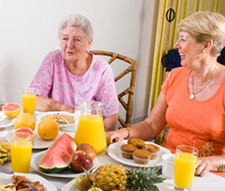 Image of women eating a big breakfast.