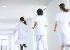 Doctors and nurses running down a hallway